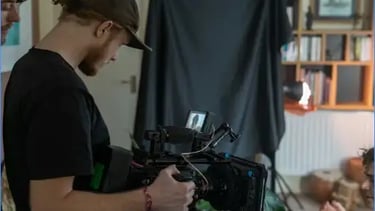 Behind-the-scenes indoor video production setup featuring a professional camera rig, studio lighting.