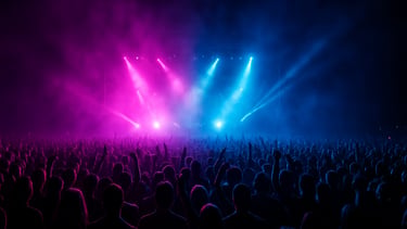 Wide panoramic shot of a massive, energetic crowd at a music festival, illuminated by vibrant magenta and electric blue stage lights, haze in the air, low horizon.