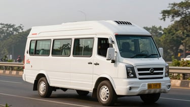 Three-quarter front of a white Tempo Traveller minibus on a Bangalore highway in bright morning light, side windows visible, large luggage compartment