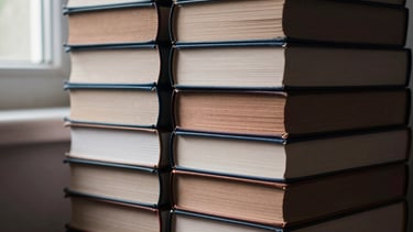 Close-up of a stack of academic research books on trauma and psychology, with subtle light and shadow falling across their spines, in a quiet study room, editorial fine art photography, soft natural window light, deep shadows, muted petroleum and copper tones, shallow depth of field, 35mm