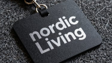 A sharp photograph of a bespoke keycard for Nordic Living, resting on a textured wool surface. The design is minimal with silver foil typography.