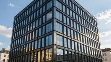 A professional corporate office building in a Central European / Slovak business district, featuring modern clean architecture with large windows. Bright daylight with a clear blue sky. The image conveys versatility and reliability. Subtle tones of dark blue, gold, and off-white in the environment.