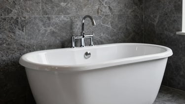 Industrial premium bathroom interior in a New York loft setting. A pristine, high-gloss white reglazed porcelain bathtub stands against a dark grey stone wall. Clean minimalist composition, soft natural lighting, professional photography showing like-new surface results.