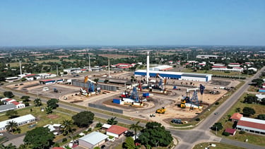 Wide panoramic aerial view of Gamba, Gabon, showing the oil terminal, Rabi Zone, and surrounding industrial areas under bright equatorial daylight, high-visibility colors, sharp focus, professional documentary style, 35mm lens