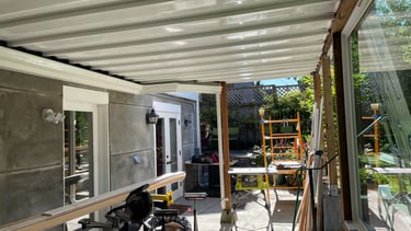 exterior construction project showing a drainage system deck cover and renovated exterior space
