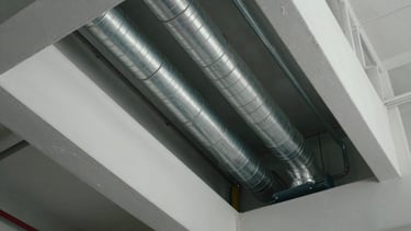 Clean architectural riser showing HVAC ducting runs and chilled water pipes inside a commercial building utility shaft.