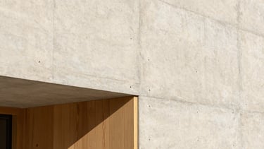 Close-up of a contemporary raw concrete wall junction with minimalist oak paneling, bright natural daylight highlighting the rich textures, architectural detail photography