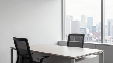 A minimalist, high-end North American office interior in New York. The scene features a clean light gray desk, a charcoal ergonomic chair, and a large window overlooking a soft city skyline. Natural light fills the room, emphasizing a clean and professional atmosphere with a palette of white, light gray, and deep charcoal.