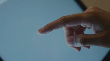 Blurred motion shot of a hand swiping on a digital screen, emphasizing smooth interaction and responsiveness, cool blue tones, East Asian / Japanese setting.
