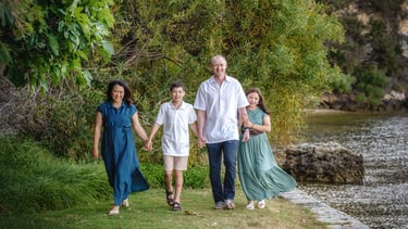 A Family of four walking along the foreshore Minim Cove by Fisher Photography