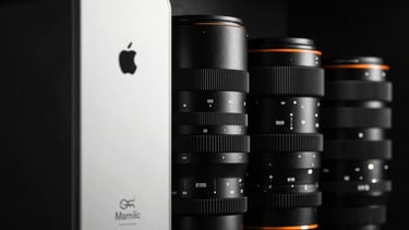 A row of high-end electronics with minimalist branding, cinematic low-key lighting, black and white aesthetic with a single orange glow detail.