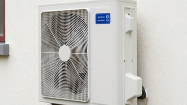 Modern heat pump unit installed outside a contemporary home in Bordeaux