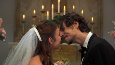 a man and woman kissing in a church