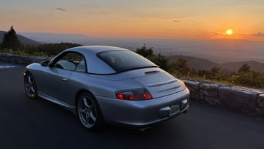 A Porsche 911 in front of a nice sunset