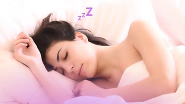 a woman sleeping in a bed with a pillow