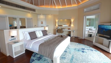 Baros Maldives overwater pool villa bedroom