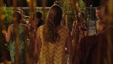 a group of people standing around a table