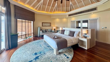 Baros Maldives overwater pool villa bedroom