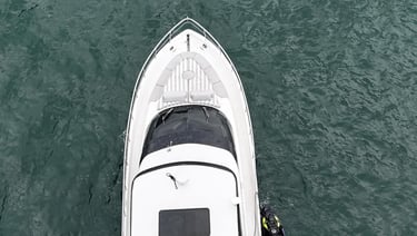a boat with a man standing on the water
