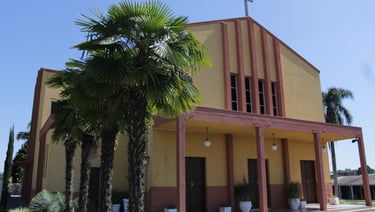 a church with a cross on the side of the road