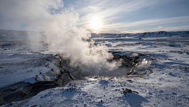 High-contrast wide anamorphic cinematic still of a cold, sub-zero graded volcanic landscape with steam rising from a fissure, dramatic low sun on the horizon.