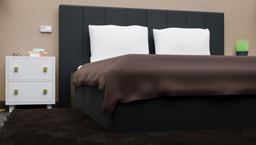 a bed with a brown blanket and a end-table 