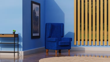 a blue chair in a blue room with a plant in the corner and table