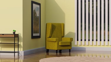 a yellow chair in a yellow room with a plant in the corner and table