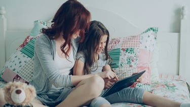 Mother and daughter using tablet together, promoting safe online practices