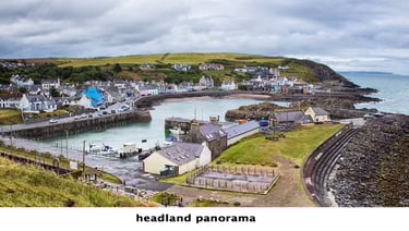 a view of portpatrick, a scottish town with a harbour and boats in the water