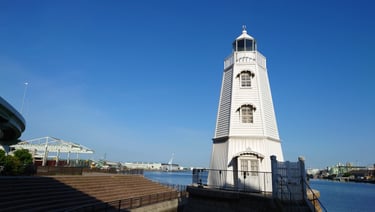 ChatGPT: 旧堺燈台の外観。明治10年建築の国内最古現存の洋式木造灯台で、白い八角形の塔身と海辺の景観が特徴｜堺市のニュースならサカイタイムズ