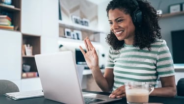 a woman with headphones and headphones on a laptop