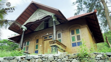 a house with a stone wall and a stone wall