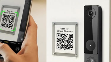 a person holding a smart phone towards an intercom unit