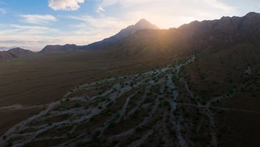 a mountain scene with a view of a valley