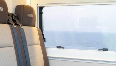 a seat in a van with a window close