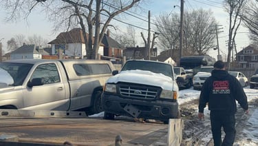 Tow truck picking up a junk car in Detroit