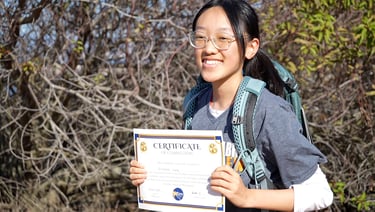 student holding a certificate