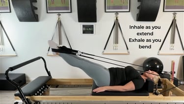 a woman working with the straps with her legs on the reformer