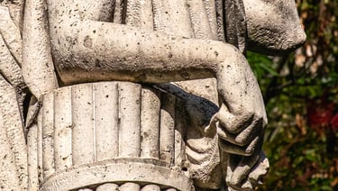 Close up on the hand of 'La Pace', fingers gently extended in a gesture of peace.