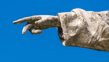Close-up of Péter Pázmány's right hand pointing forward, symbolizing guidance and revival.