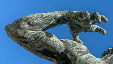 Close-up of the archer’s releasing hand, capturing a sense of strength, tension, and vigor.