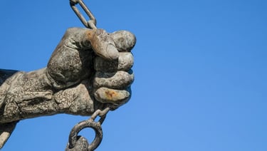 Close-up of Imre Soós's sculpted hand as if breaking free from a chain, symbolizing desire.