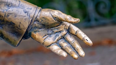 Close-up view of Ronald Reagan statue’s hand, symbolizing leadership and strength.