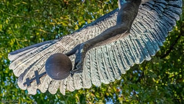 Close-up of Archangel Gabriel’s hand as the orb tumbles from his grasp, symbolizing loss and pain.