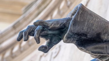 Close-up of the bronze hand of the wounded soldier from the ELTE University heroic memorial.