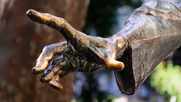 Close-up of Liszt's sculpted right hand, detailed and poised, symbolizing expressive artistry.