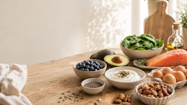 Healthy foods for hormone balance including salmon, avocado, eggs, blueberries, leafy greens, Greek