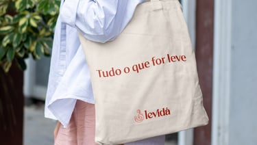 a woman in a white shirt and pink pants with a baguet bag