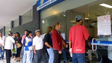 a group of people standing in line at a bank